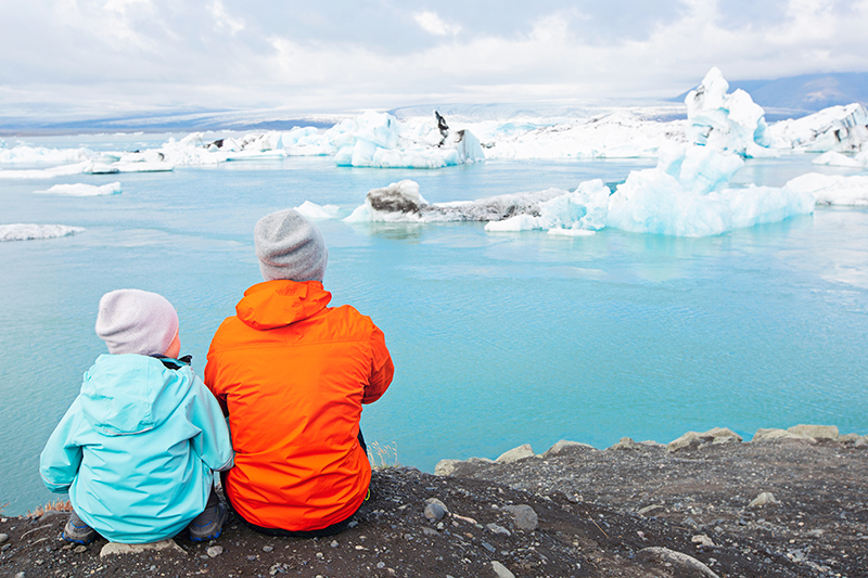 Father and Son in Patagonia looking at icebergs