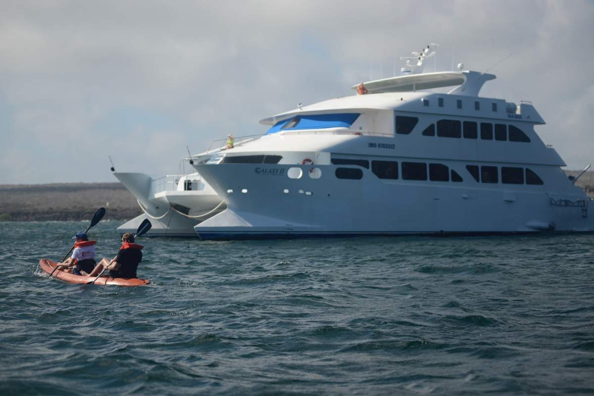 EcoGalaxy cruise ship with kayakers in front