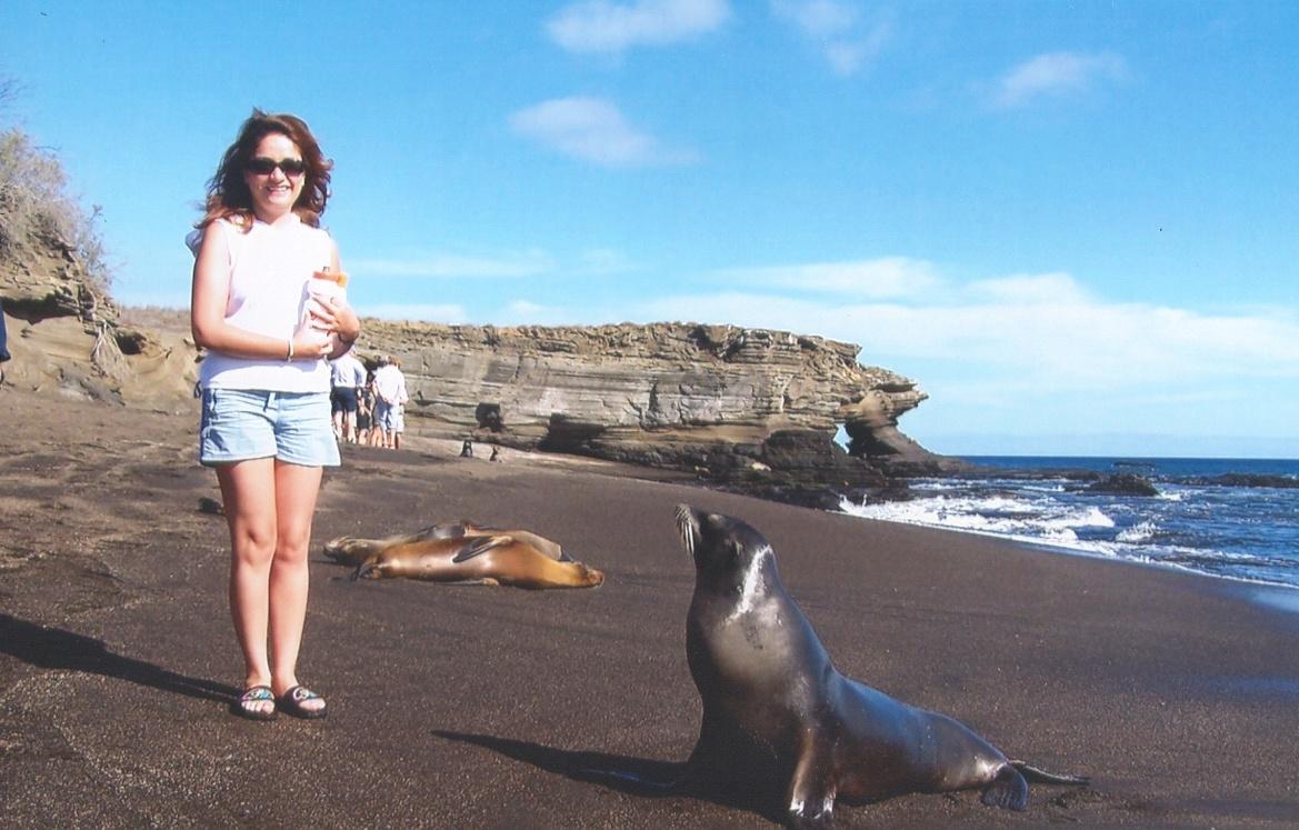 Alex Paz with sea lion on the beach in Ecuador